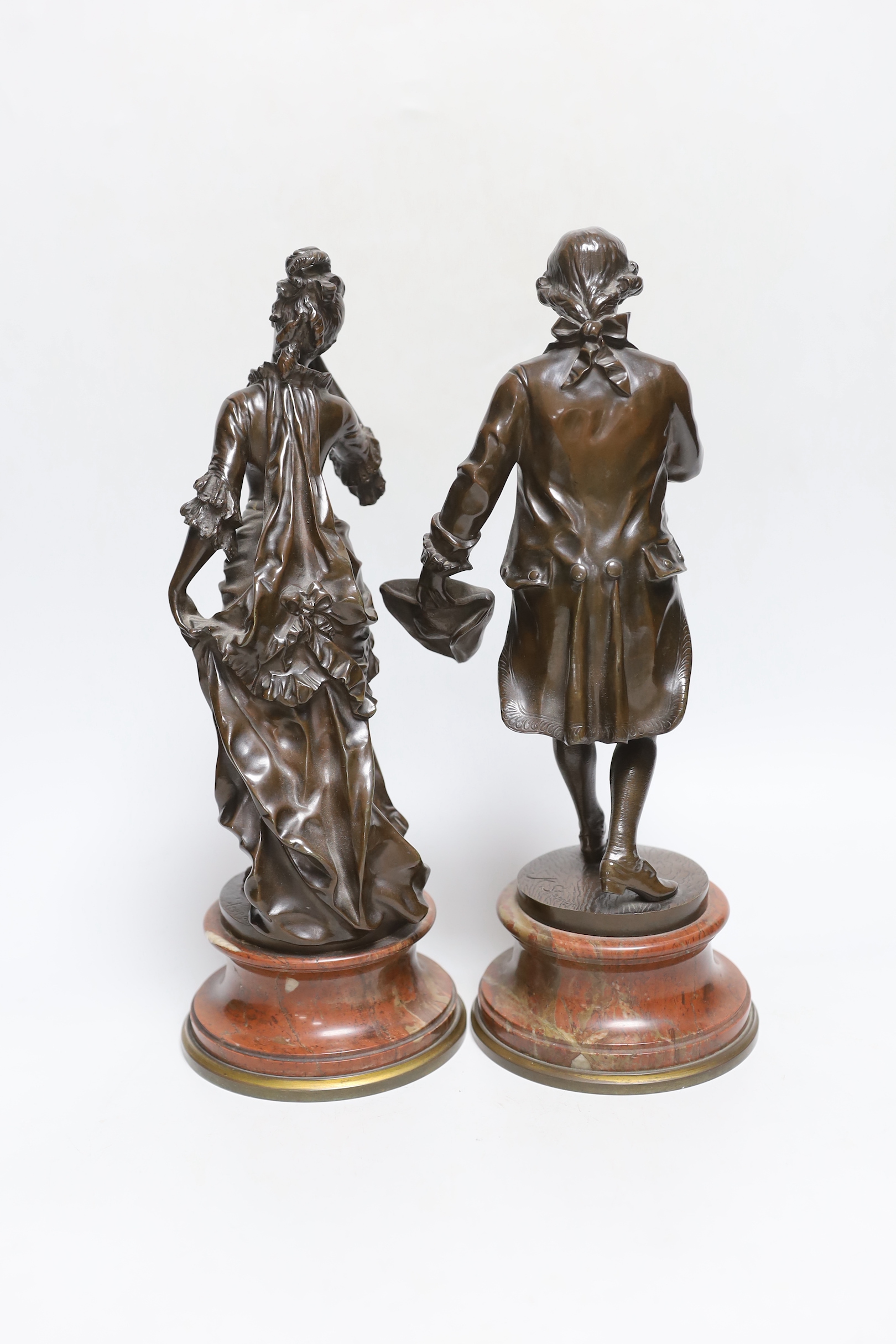 Karl Sterrer (1844-1918. A pair of bronze figures of a lady and gentlemen in 18th century dress, on rouge marble and ormolu mounted bases, signed, 31cm high